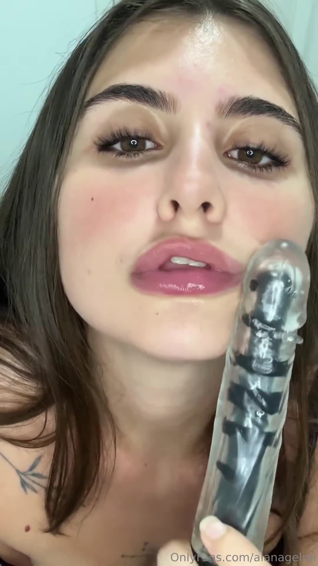 Alana Gelmi having fun with her toy in her mouth, as if she was enjoying an intimate moment with her partner