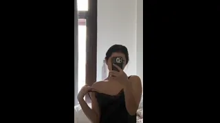 Preview of Carolina Bell Pelada, showing the utilities in front of the mirror in a spicy video